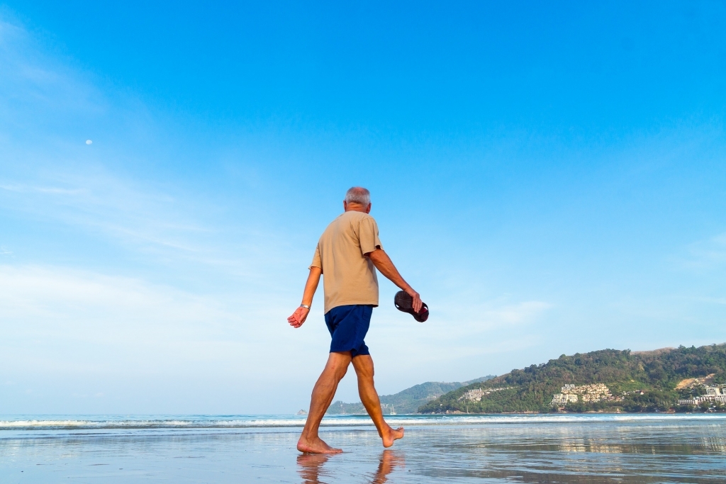 man walking along the beach